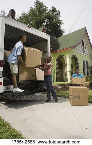 Family unloading boxes from moving truck View Large Photo Image Stock Photograph - Family unloading boxes from moving truck. Fotosearch