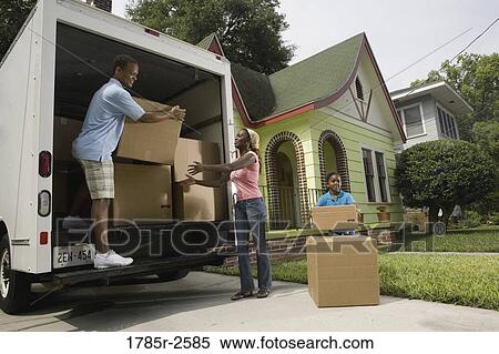 Family unloading boxes from moving truck View Large Photo Image Stock Photography - Family unloading boxes from moving truck. Fotosearch