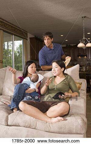 Stock Image - Family watching tv. Fotosearch