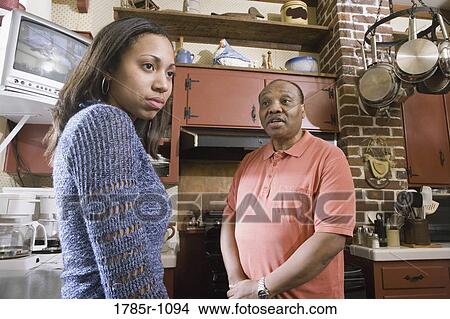 Father and daughter conversing in kitchen View Large Photo Image Picture - Father and daughter conversing in kitchen. Fotosearch