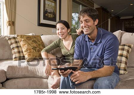 Father and daughter on sofa watching TV View Large Photo Image Stock Photo - Father and daughter on sofa watching TV. Fotosearch
