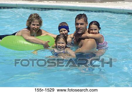 Father and mother with their son and two daughters in a swimming pool View Large Photo Image Stock Photo - Father and mother with their son and two daughters in a swimming pool. Fotosearch
