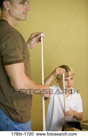 Father and son chalking cue sticks by pool table View Large Photo Image Stock Image - Father and son chalking cue sticks by pool table. Fotosearch