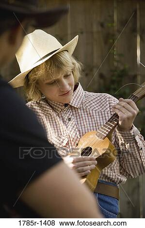 Father and son playing guitar, country music View Large Photo Image Stock Photo - Father and son playing guitar, country music. Fotosearch