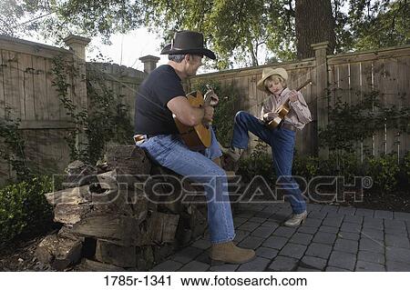 Father and son playing guitar together View Large Photo Image Stock Image - Father and son playing guitar together. Fotosearch