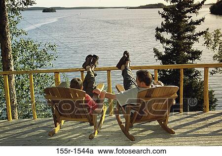 Father and son sitting together on rocking chairs, Canada View Large Photo Image Stock Image - Father and son sitting together on rocking chairs, Canada. Fotosearch
