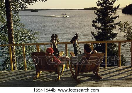 Father and son sitting together on rocking chairs, Canada View Large Photo Image Stock Image - Father and son sitting together on rocking chairs, Canada. Fotosearch