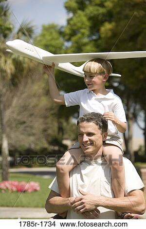 Picture - Father and son with a toy glider. Fotosearch