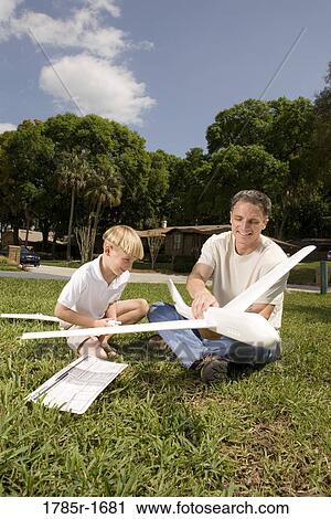 Father and son with a toy glider View Large Photo Image Stock Image - Father and son with a toy glider. Fotosearch
