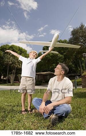 Father and son with a toy glider View Large Photo Image Stock Image - Father and son with a toy glider. Fotosearch