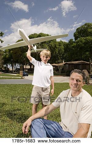 Father and son with a toy glider View Large Photo Image Stock Image - Father and son with a toy glider. Fotosearch