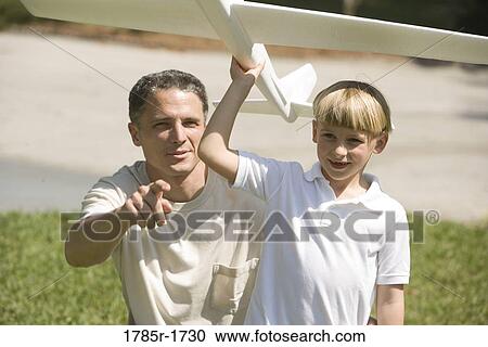 Father and son with a toy glider View Large Photo Image Stock Image - Father and son with a toy glider. Fotosearch