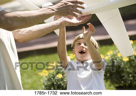 Father and son with a toy glider View Large Photo Image Stock Image - Father and son with a toy glider. Fotosearch