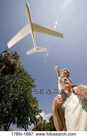 Father and son with a toy glider View Large Photo Image Stock Photo - Father and son with a toy glider. Fotosearch