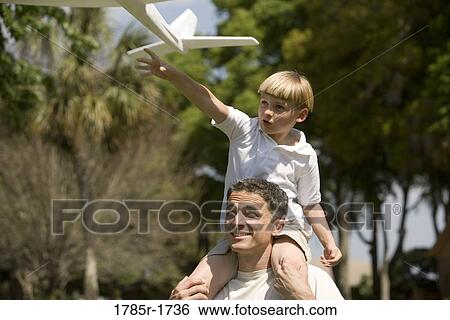Father and son with a toy glider View Large Photo Image Stock Photograph - Father and son with a toy glider. Fotosearch