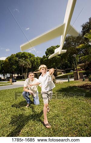 Father and son with a toy glider View Large Photo Image Stock Photography - Father and son with a toy glider. Fotosearch