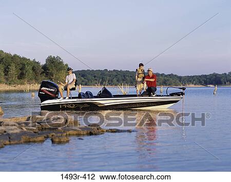 Stock Image - Father fishing with his two sons. Fotosearch