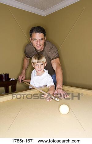 Father showing his young son how to play pool View Large Photo Image Stock Image - Father showing his young son how to play pool. Fotosearch