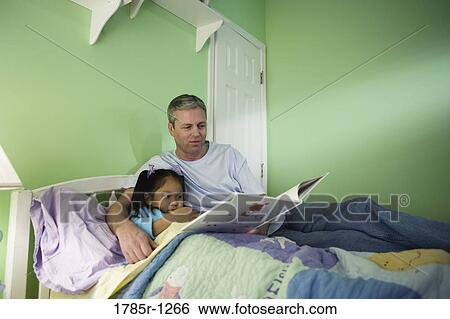 Father with daughter reading book in bedroom View Large Photo Image Stock Photograph - Father with daughter reading book in bedroom. Fotosearch
