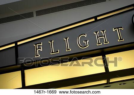 Flight sign lit up on a building View Large Photo Image Stock Photo - Flight sign lit up on a building. Fotosearch