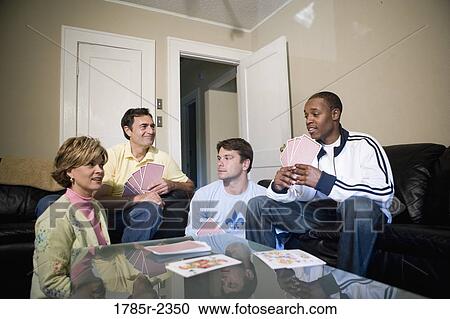 Friends playing cards at home View Large Photo Image Stock Image - Friends playing cards at home. Fotosearch