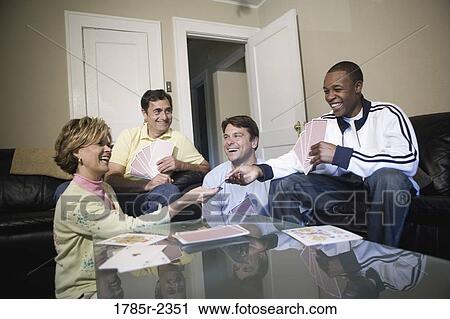 Friends playing cards at home View Large Photo Image Stock Image - Friends playing cards at home. Fotosearch