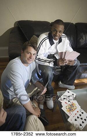 Friends playing cards at home View Large Photo Image Stock Image - Friends playing cards at home. Fotosearch