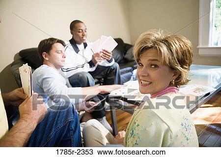 Friends playing cards at home View Large Photo Image Stock Image - Friends playing cards at home. Fotosearch