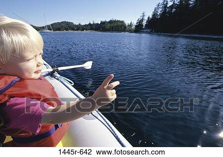 Stock Image - Girl in an inflatable raft. Fotosearch