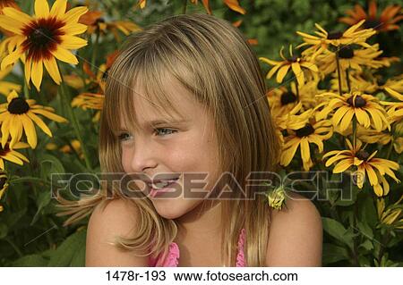 Girl in front of flowers View Large Photo Image Stock Image - Girl in front of flowers. Fotosearch