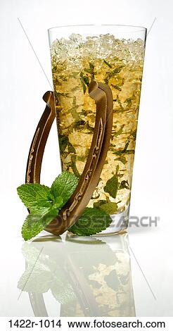 Glass of mint julep cocktail with a horseshoe and mint garnish View Large Photo Image Picture - Glass of mint julep cocktail with a horseshoe and mint garnish. Fotosearch