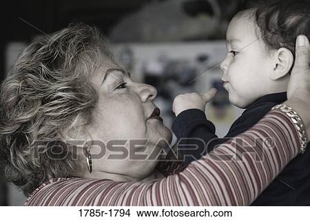 Picture - Grandmother holding her grandson. Fotosearch