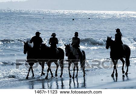 Group of people on horseback at the beach View Large Photo Image Stock Image - Group of people on horseback at the beach. Fotosearch
