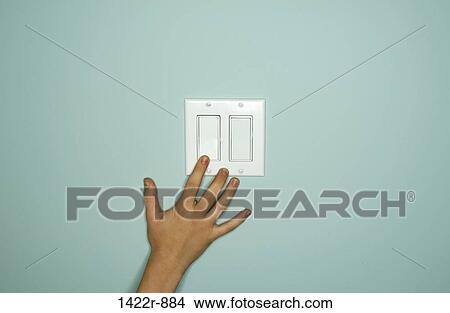 Hand reaching a light switch View Large Photo Image Picture - Hand reaching a light switch. Fotosearch