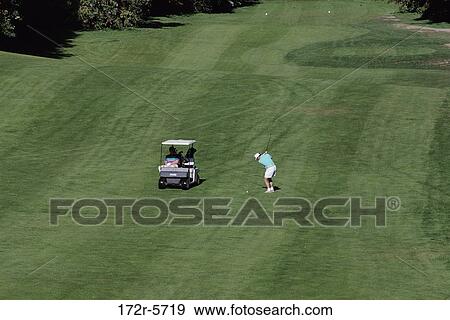 Stock Photo - High angle view of a man playing golf. Fotosearch