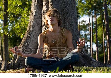 Hippie meditating under tree View Large Photo Image Stock Photo - Hippie meditating under tree. Fotosearch