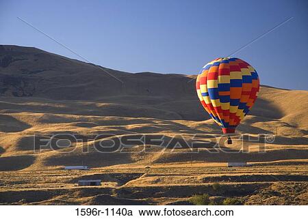 Stock Image - Hot air balloon flying in the air, Horse Heaven Hills, The Great Prosser Balloon Rally, Prosser, Washington State, USA. Fotosearch