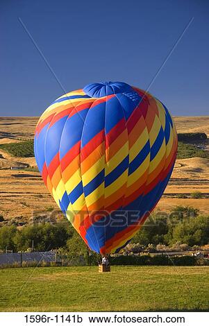 Hot air balloon over a landscape, Horse Heaven Hills, The Great Prosser Balloon Rally, Prosser, Washington State, USA View Large Photo Image Stock Image - Hot air balloon over a landscape, Horse Heaven Hills, The Great Prosser Balloon Rally, Prosser, Washington State, USA. Fotosearch