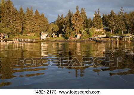 Stock Image - Houses at the waterfront at sunset, Meyers Chuck, Alaska, USA. Fotosearch