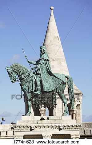 Hungary, Budapest, Equestrian statue of St Stephens First King of Hungary with tower of Fishermen's Bastion in background View Large Photo Image Stock Photo - Hungary, Budapest, Equestrian statue of St Stephens First King of Hungary with tower of Fishermen's Bastion in background. Fotosearch