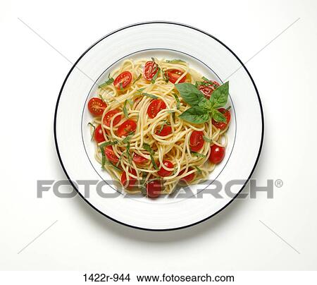 Picture - Large white dining plate with spaghetti pasta, sliced tomatoes and basil. Fotosearch