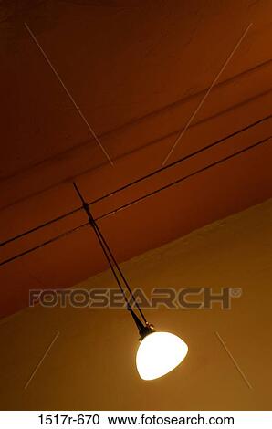 Stock Image - Light fixture suspended from the ceiling. Fotosearch