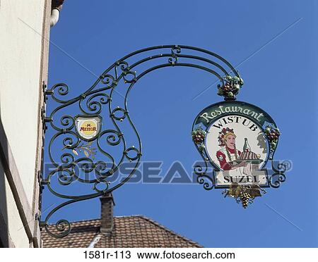 Stock Image - Low angle view of a restaurant sign, Eguisheim, France. Fotosearch