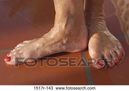 Stock Image - Low section view of a woman's feet. Fotosearch