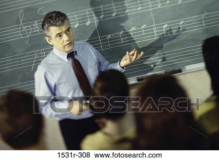 Male music teacher in a classroom View Large Photo Image Stock Photo - Male music teacher in a classroom. Fotosearch