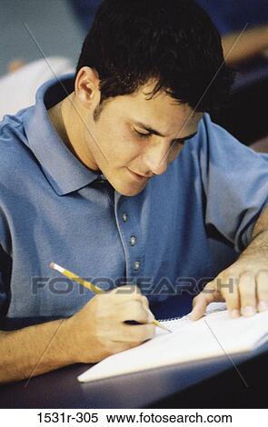 Male student writing in notebook View Large Photo Image Stock Photography - Male student writing in notebook. Fotosearch