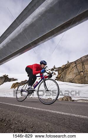 Man riding a bicycle downhill, U. S. Route 40, Donner Summit, California, USA View Large Photo Image Stock Photo - Man riding a bicycle downhill, U. S. Route 40, Donner Summit, California, USA. Fotosearch