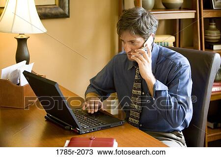 Man using laptop computer in the study of his home View Large Photo Image Stock Image - Man using laptop computer in the study of his home. Fotosearch