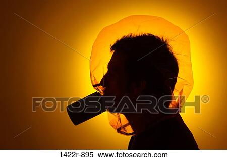 Stock Photography - Man wearing emergency fire escape hood. Fotosearch