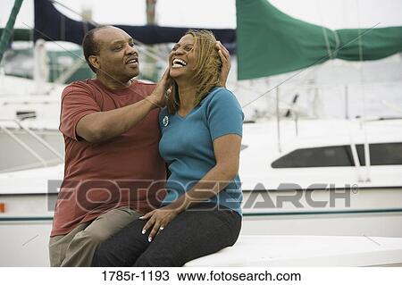 Mature African American couple laughing at marina View Large Photo Image Stock Image - Mature African American couple laughing at marina. Fotosearch